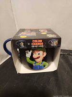 Retail box front showing Luigi graphic and color change feature