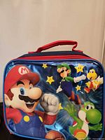 Front view showing Mario, Luigi, Yoshi graphics and handle