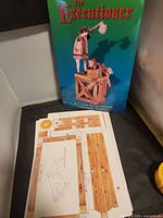 Front cover of Executioner model kit and loose unpunched cardstock sheets visible