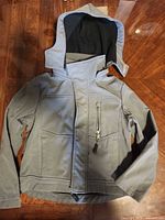 Front view of grey hooded jacket laid flat