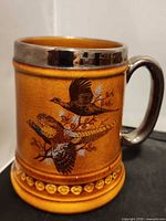 Front view showing pheasant design and metal rim