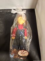 Full view of sealed Little Dippers wax doll figurine in plastic wrap