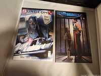 Front covers of both comics in sleeves