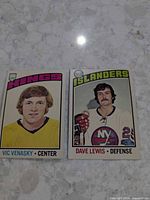 Fronts of both hockey cards showing player images and team headings