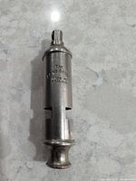 Full view of whistle front showing brand stamping and overall form