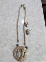 Front view necklace with pendant and matching earrings