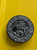 Front of carved black stone medallion