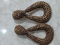 Front view of both rhinestone-covered drop earrings