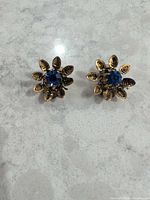 Front view showing floral design and blue rhinestones