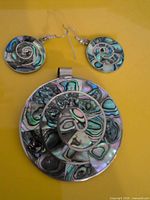 Front view showing pendant and matching earrings with abalone inlay spiral pattern