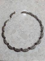 Full view of necklace laid flat showing design and stone placement