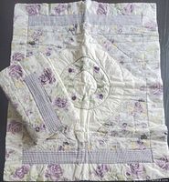 Both pillow shams, one folded, showing full pattern and quilting