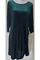 Full front view of forest green velvet dress on mannequin