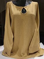 Front view of gold sparkle sweater displayed on mannequin