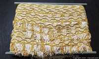 Full roll of gold and white fringe trim on card