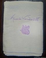 Folded towel showing lavender Gloria Vanderbilt signature and swan embroidery