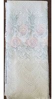 Folded panel showing floral rose embroidery and lace texture