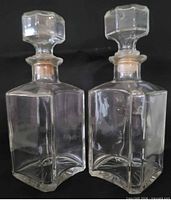 Front view showing both glass decanters and stoppers