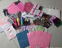 Full assortment laid out showing bags, boxes, pouches, ribbons, tissue, filler