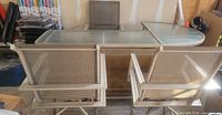 Rear view of two swivel chairs and glass-top bar table