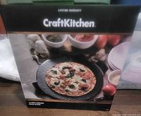Front of boxed 13" CraftKitchen ceramic pizza stone