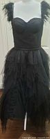 Front full view of layered black tulle midi dress on mannequin