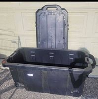 Overall view of open Husky rolling tote with lid standing behind