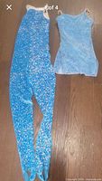 Both costumes side by side on floor