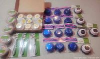 Assorted baking cups packs, patriotic blue foil cups grid, heart cups, smiley packs in box, three vegetable peelers