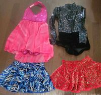All four dance costumes laid out