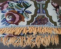 Fringed edge and woven floral pattern close-up