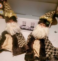 Two Santa bottle covers in front of boxed centerpiece