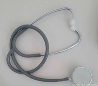 Grey Riester Duplex 2 stethoscope coiled, showing chestpiece and ear tips
