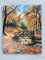 Front view of entire canvas showing autumn forest scene with bridge