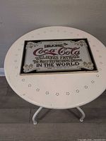 Front view of entire Coca-Cola sign on table