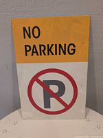 Front view of the steel No Parking sign showing text and symbol