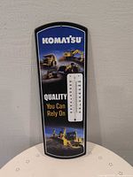 Front view showing Komatsu graphics and thermometer scale
