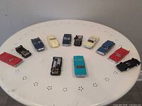 Group shot of all eleven toy cars arranged on table