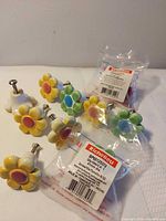 Group of ceramic flower knobs and packaged spares