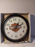 Front view of Harley-Davidson wall clock in box