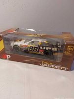 Front angled view of boxed die-cast car showing livery and scale