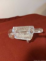 Side view of crystal wheelbarrow dish showing cut pattern and front wheel