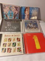 Six CDs laid out showing full fronts