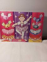 Front view of puzzle board and all clothing pieces