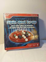 Front of sealed Spin and Trap box showing game image and title