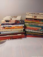 Two stacks of assorted books on a table