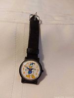 Front view of watch showing Donald Duck dial and strap