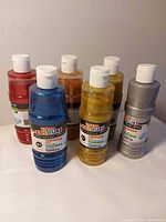 Six bottles assorted glitter tempera paint