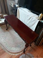 Top and front view of reddish brown hall table