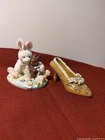 Front view of bunny figurine and yellow decorative shoe